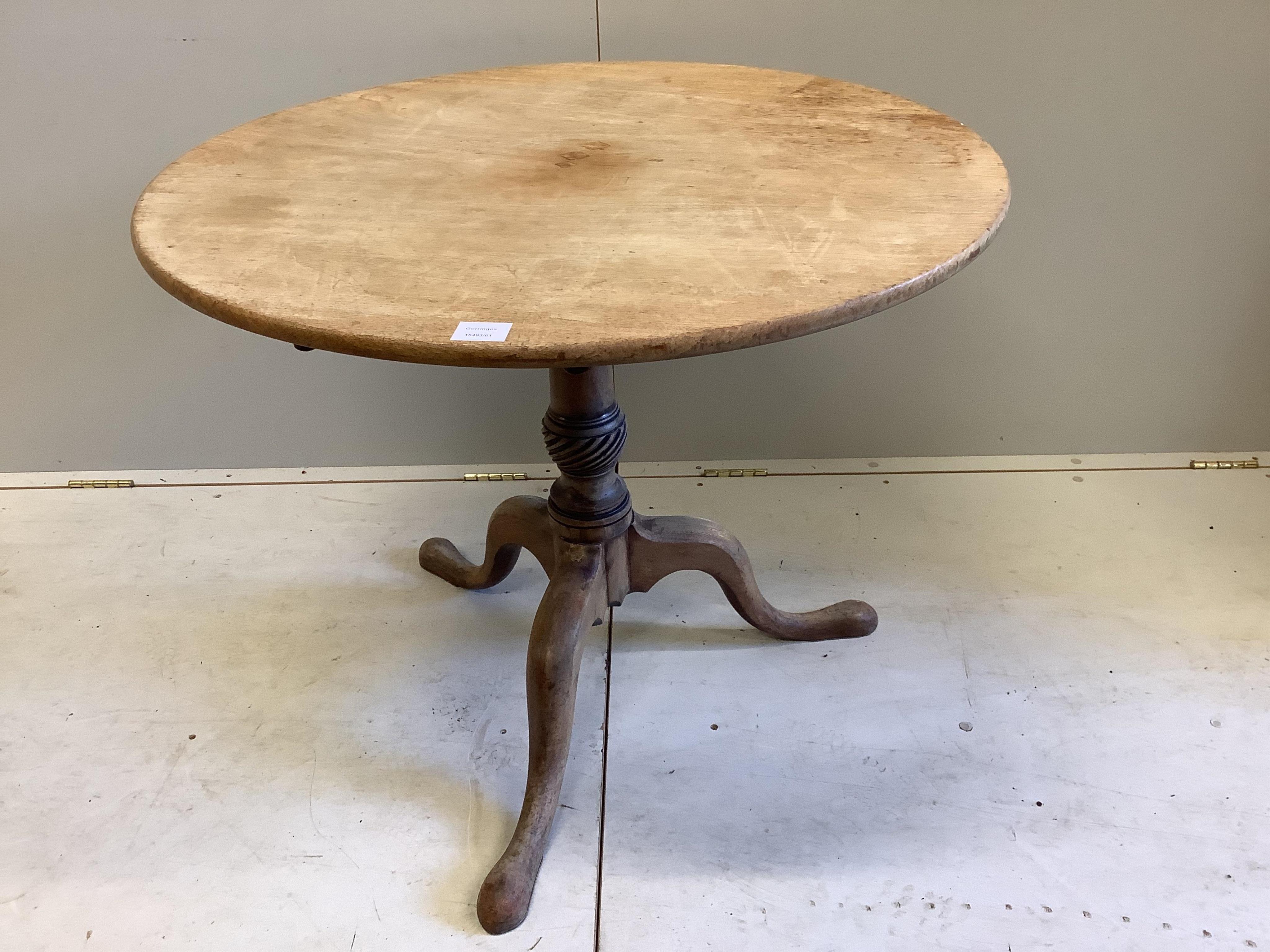 A George III circular faded mahogany tilt top tripod tea table, diameter 85cm, height 70cm. Condition - poor